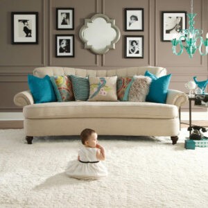 Baby sitting on carpet flooring | St.Francis Flooring Inc.